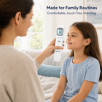 Parent using a non-contact infrared forehead thermometer for a child at home